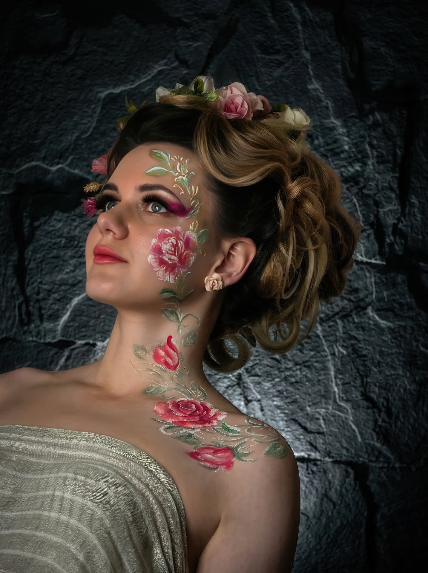 Woman with a floral hair piece looking upward, painted roses on her neck