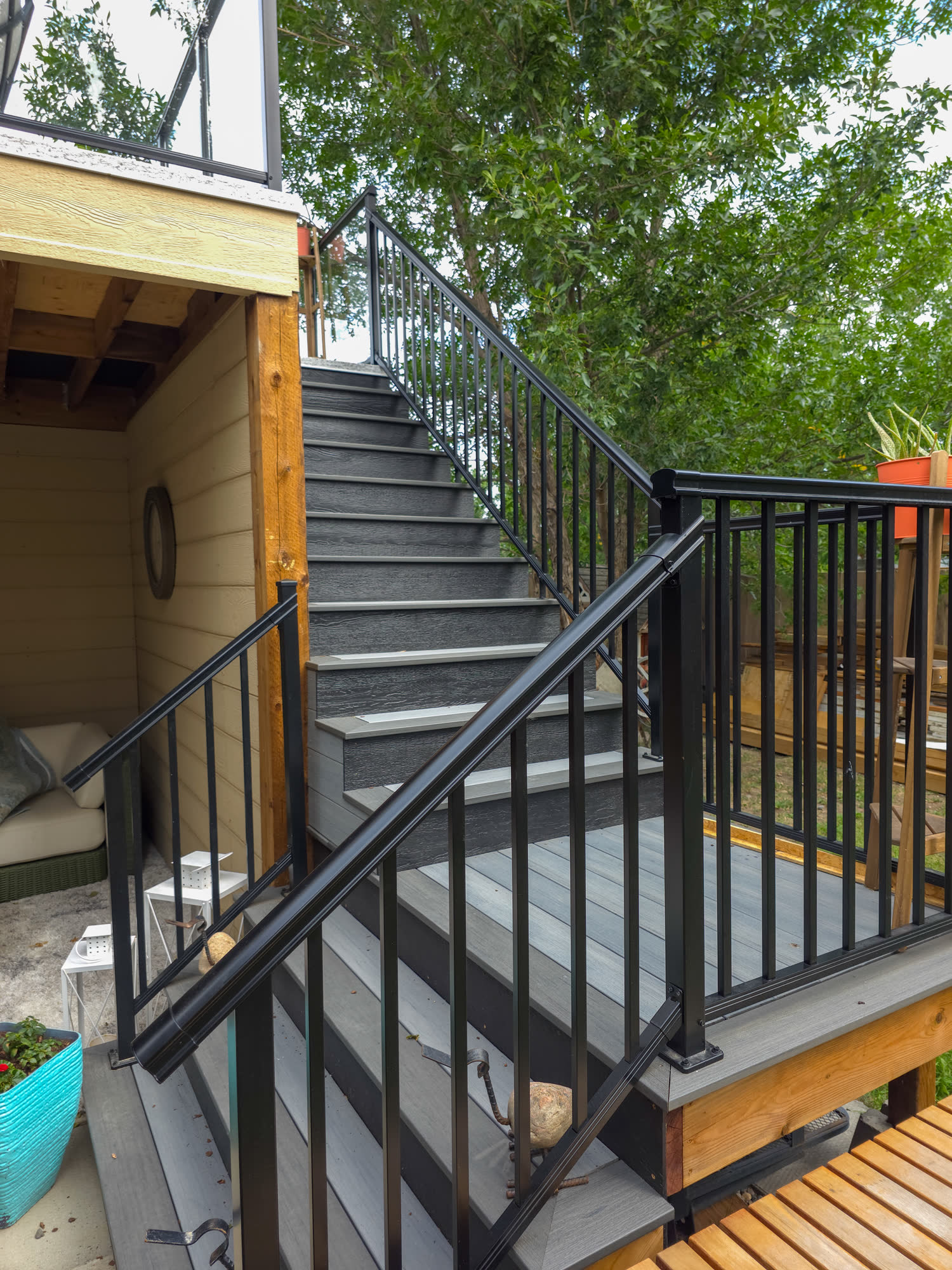Composite deck stairs with black aluminum railings